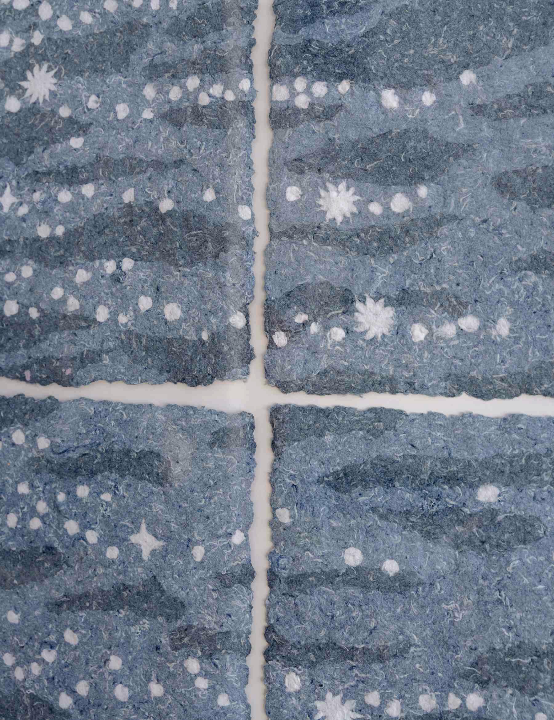 close up of paper pulp shimmer piece, made from discarded denim jeans